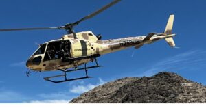 Tactical helicopter flying over the Mojave Desert during a 4th of July aerial shooting experience near Las Vegas.