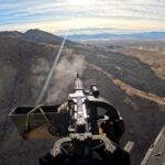 View from helicopter shooting fully automatic machine gun over Mojave Desert on an aerial adventure tour near Las Vegas to honor memorial day.