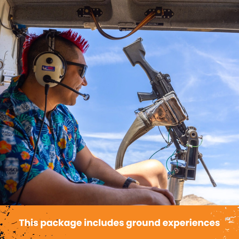 Man inside helicopter with headset and M240 machine gun