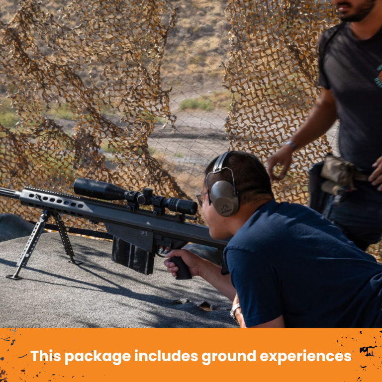 Shooter aiming rifle at range with camouflage netting in the background