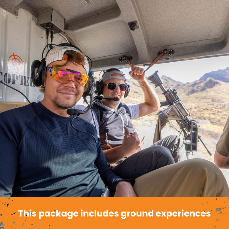 Couple smiling after deluxe helicopter shooting tour