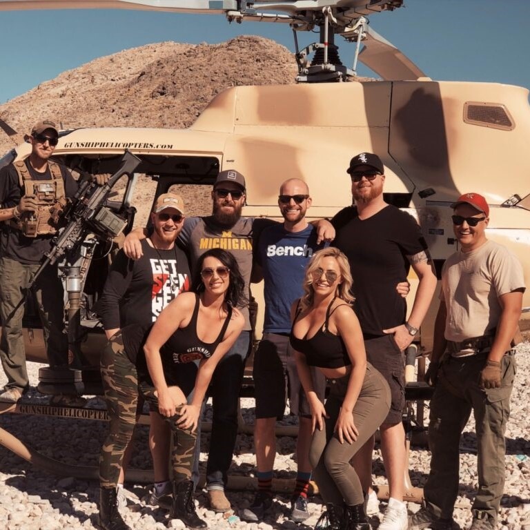 Group photo of guests with helicopter and crew after aerial experience