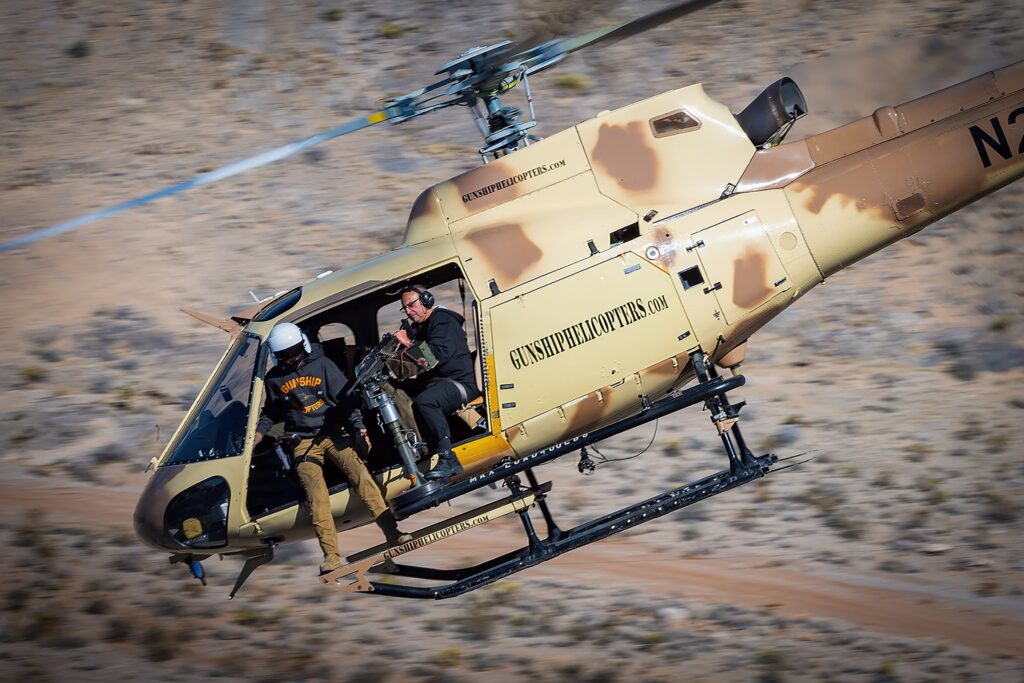Gunship Helicopter flying fast over the desert during an aerial shooting mission