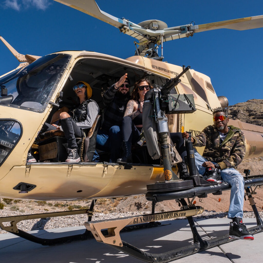 Group of guests posing with helicopter after flight experience