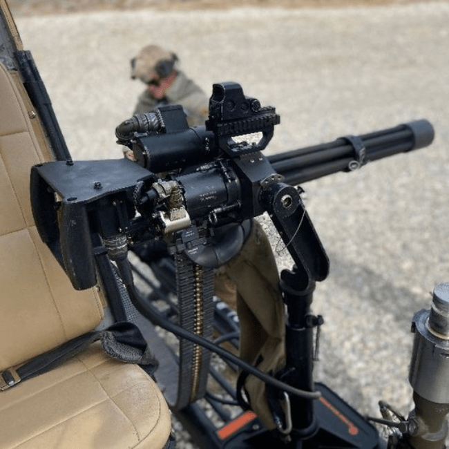 Close-up of minigun mounted on a helicopter seat at Gunship Helicopters