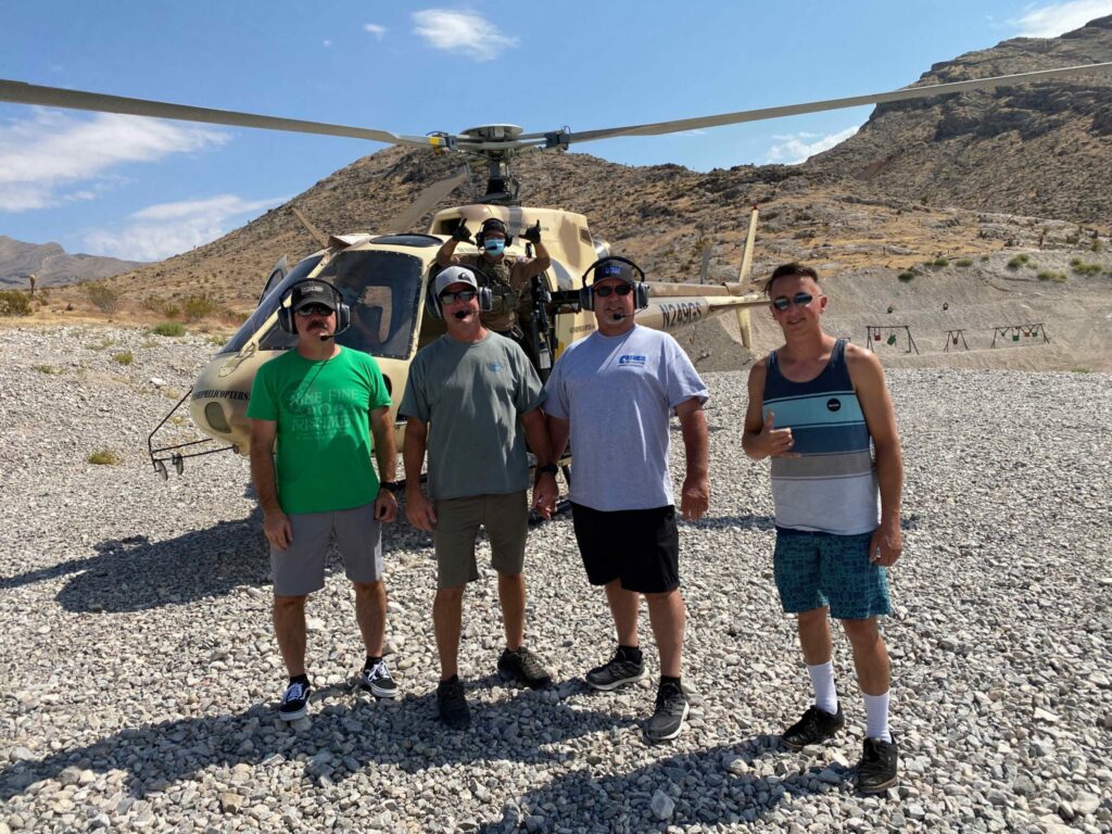 ultimate squad up - Group of four men standing in front of a Gunship Helicopters aircraft at the shooting range