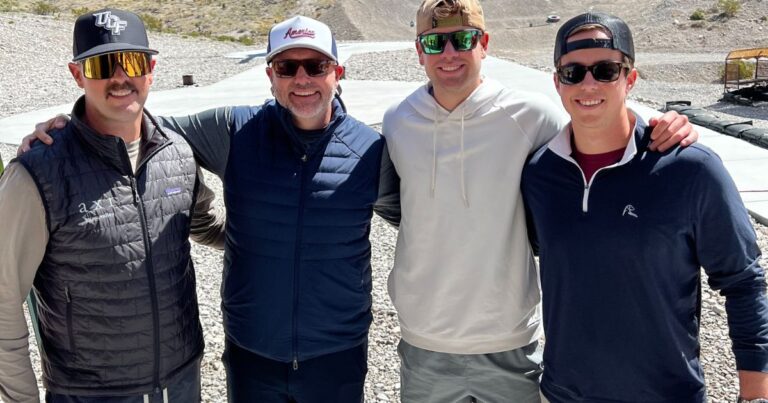 Group of friends smiling together at Gunship Helicopters’ outdoor shooting range near Las Vegas before experiencing a tactical helicopter gun range adventure.
