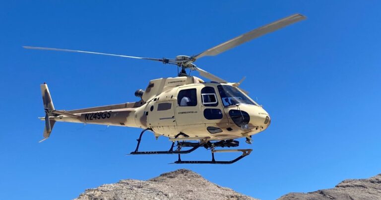 Gunship Helicopters tactical aircraft in mid-flight over the Mojave Desert during an aerial gun range experience near Las Vegas. From ground to air Gunship Helicopters can accommodate.