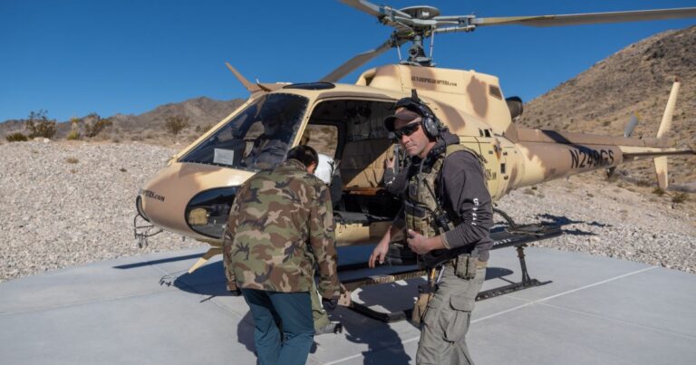 Certified range safety officer guides a guest during pre-flight safety checks at Gunship Helicopters before an aerial shooting experience in the sky in the Mojave Desert near Las Vegas.