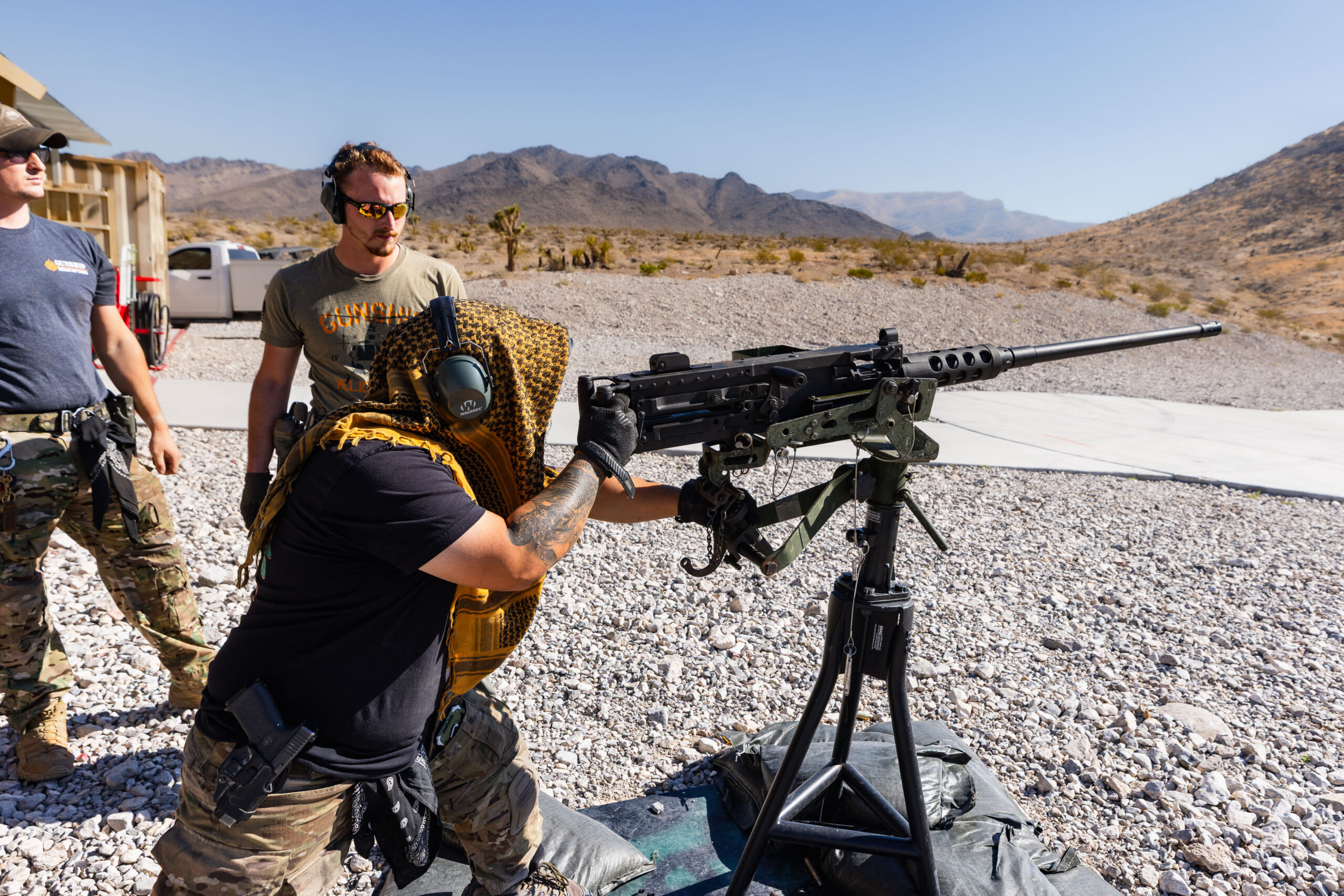 Guest feels the power of the Barrett .50 caliber at Gunship Helicopters’ outdoor shooting range in the Mojave Desert, guided by veteran range safety officers.