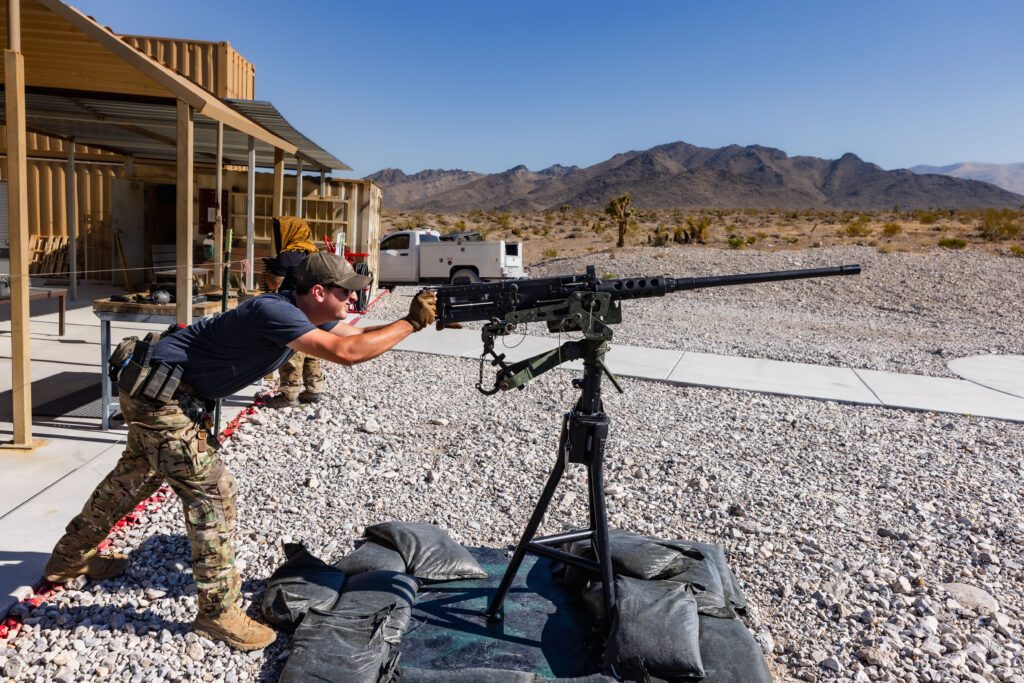 Veteran range safety officer engaged in veteran affairs at Gunship Helicopters’ Mojave Desert outdoor shooting range in Las Vegas, guiding guests on mounted heavy machine guns.