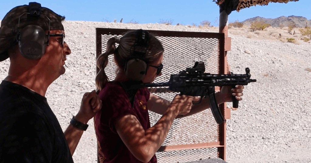 Range safety officer guiding guest with MP5 during veteran-led shooting experience in Las Vegas