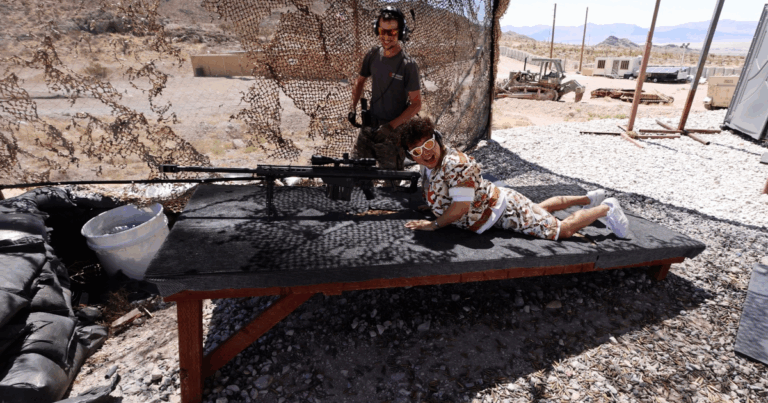 Veteran range safety officer guiding veteran guest at a discount rate during Nevada shooting experience with Gunship Helicopters