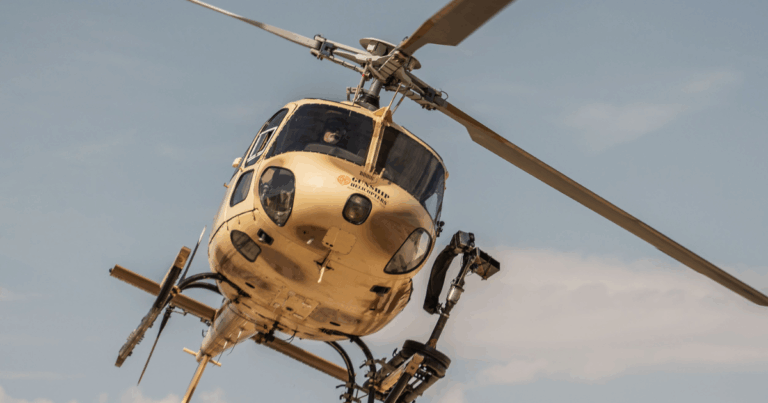 Participants firing fully automatic machine guns during an extreme helicopter shooting experience over the Mojave Desert near Las Vegas