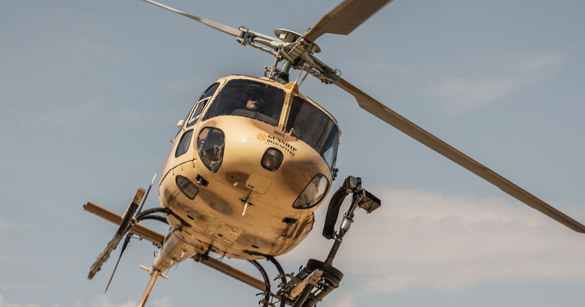 Participants firing fully automatic machine guns during an extreme helicopter shooting experience over the Mojave Desert near Las Vegas