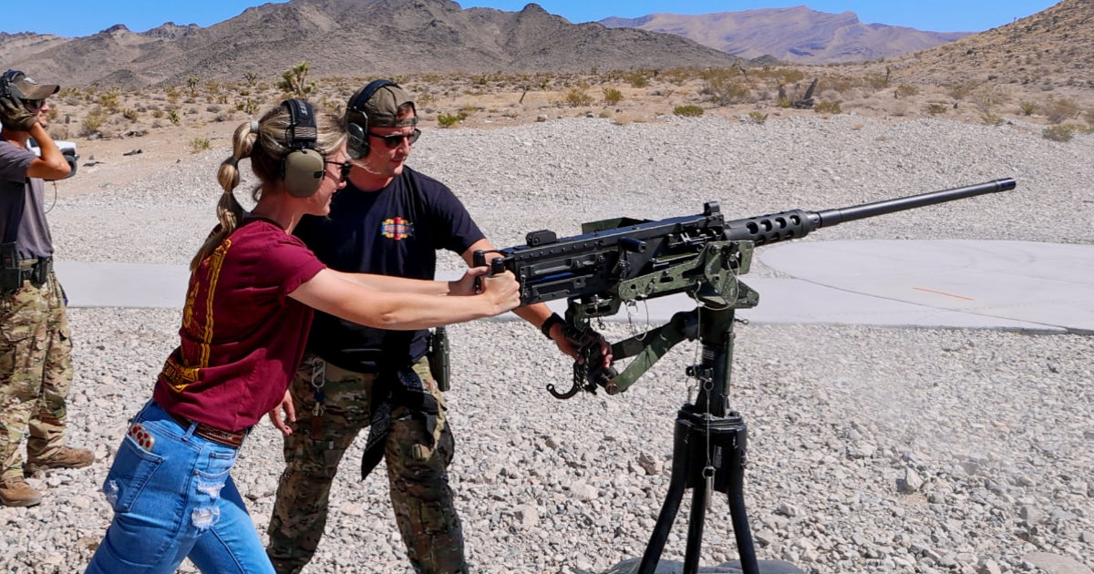 Range safety officer guiding guest through firearm safety protocols at Gunship Helicopters near Las Vegas Nevada