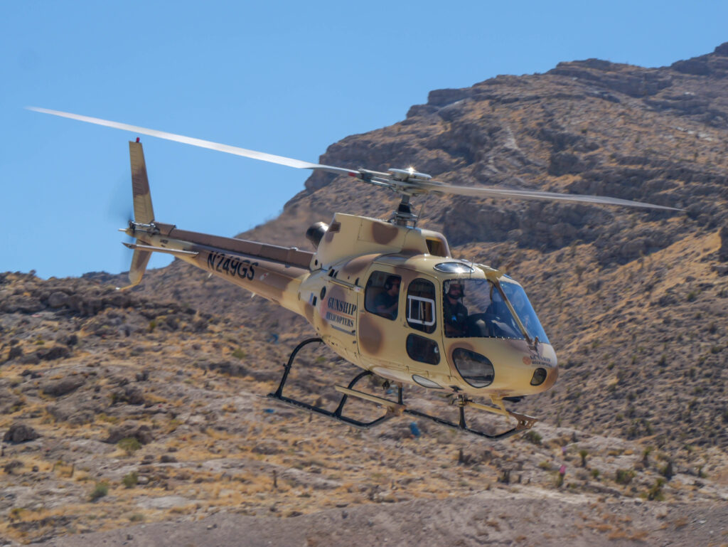 Gunship Helicopters aircraft flying over the Nevada desert during an award winning and top choice aerial shooting adventure in Las Vegas