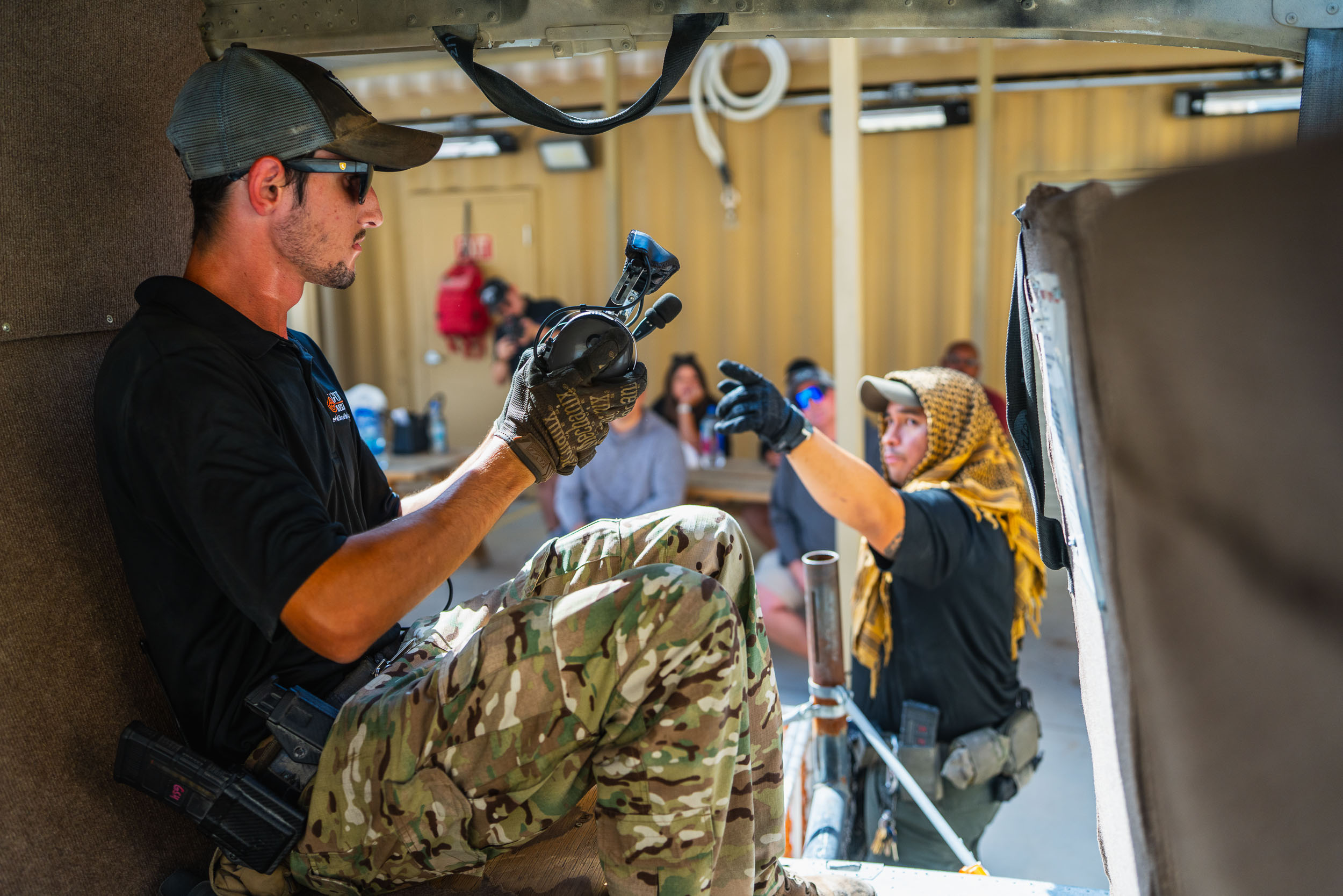 Guest participating in an top choice aerial shooting experience with safety guidance from a range safety officer at Gunship Helicopters in Las Vegas