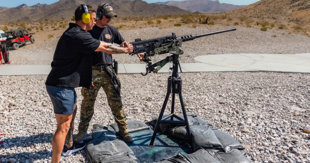 Guest firing the M240 with guidance from a range safety officer awaiting a helicopter ride at Gunship Helicopters outdoor Nevada shooting range