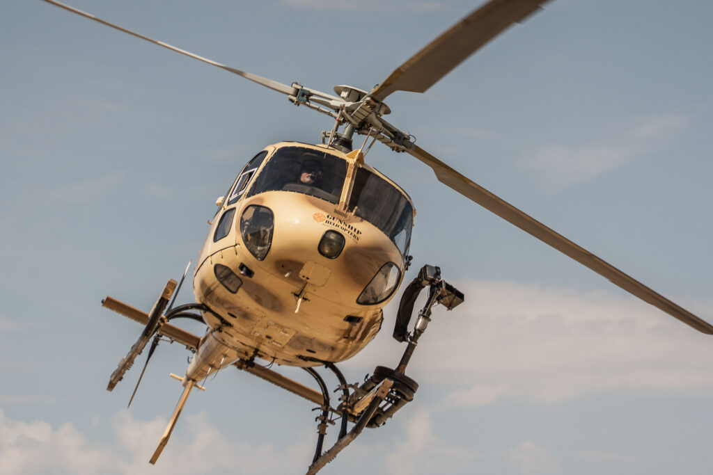 Gunship Helicopters aircraft flying low through Nevada desert terrain during controlled rotorcraft operations for aerial shooting safety