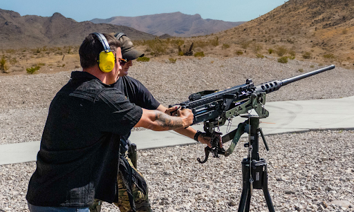 A veteran range safety officer supervises a guest during an extreme outdoor shooting experience at Gunship Helicopters in Nevada.