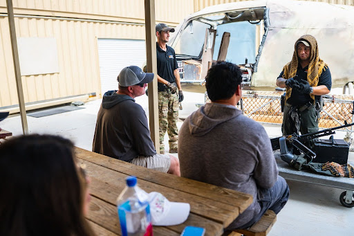 Veteran range safety officers lead a pre-flight safety briefing at Gunship Helicopters, sharing an extreme military experience as part of Las Vegas adventure tourism.