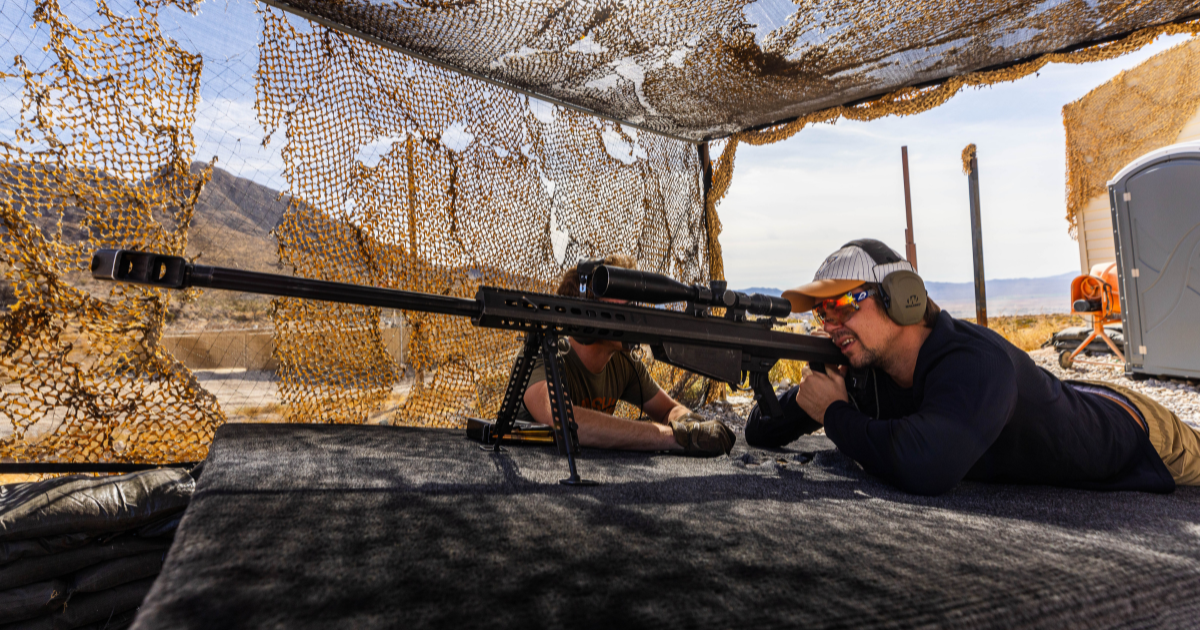 Guest participating in a Las Vegas outdoor shooting experience on a Mojave Desert range with guidance from professional range safety officers.
