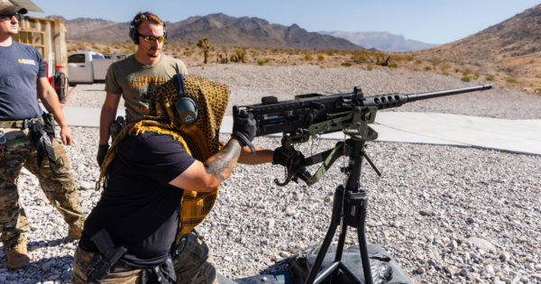 Guest firing the Ma Deuce .50 caliber firearm on a ground-mounted platform during a Las Vegas outdoor shooting experience in the Mojave Desert