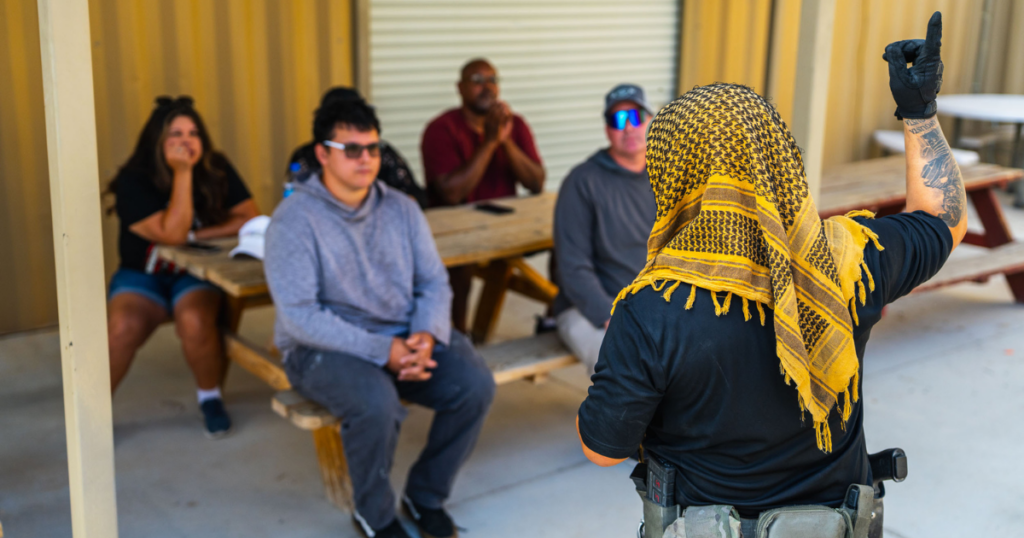Gunship Helicopters safety officer briefing guests before a helicopter gun range Nevada aerial shooting experience