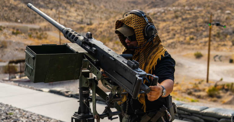 Gunship Helicopters team member demonstrating a mounted machine gun at a veteran-friendly shooting range near Las Vegas