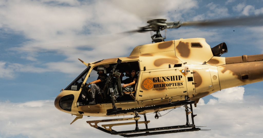 Gunship Helicopters Nevada their aircraft in flight during a helicopter gunship Nevada experience featuring an open-door aerial shooting adventure over the Nevada desert.