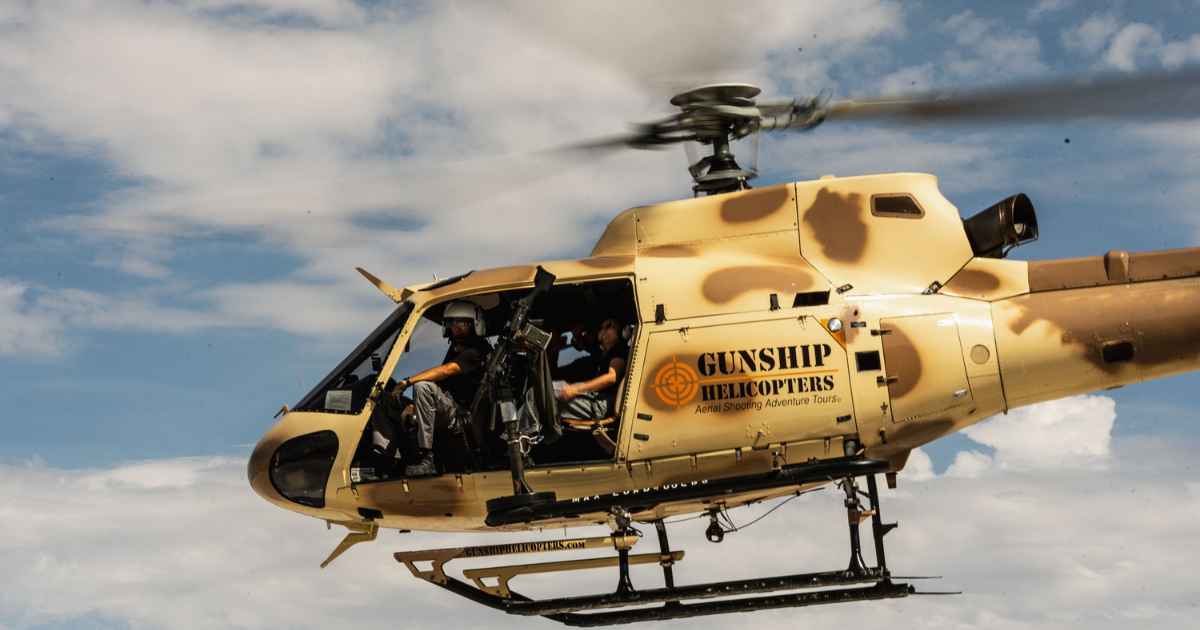 Gunship Helicopters Nevada their aircraft in flight during a helicopter gunship Nevada experience featuring an open-door aerial shooting adventure over the Nevada desert.