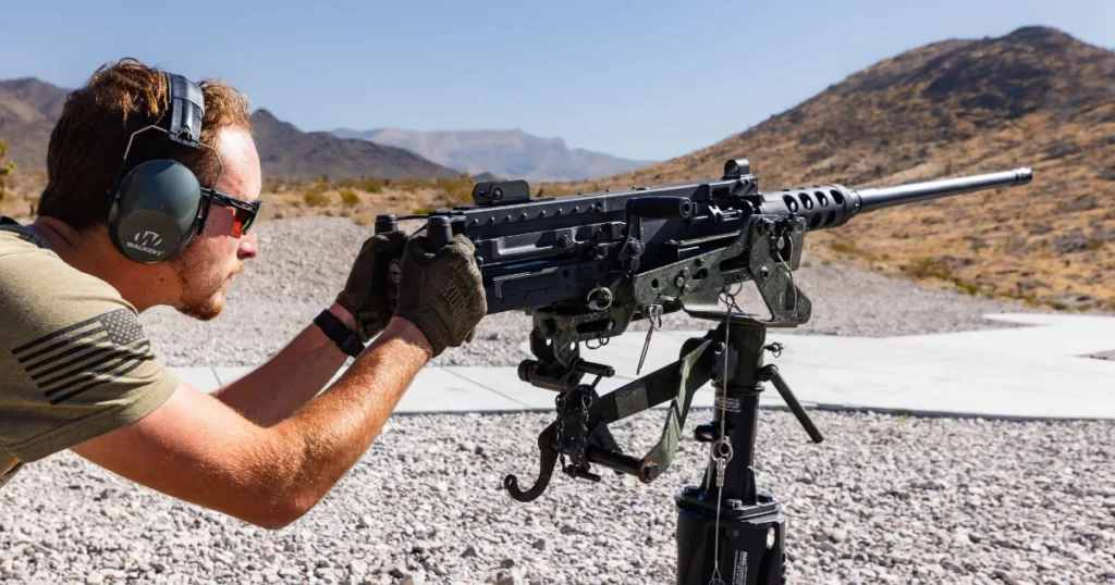 Guest operating a mounted M2 Browning .50 caliber machine gun at an outdoor shooting range near Las Vegas